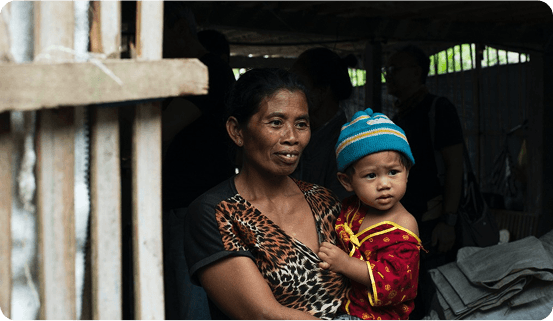 Mother holding child - community impact